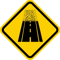 Warning for an unpaved road surface.