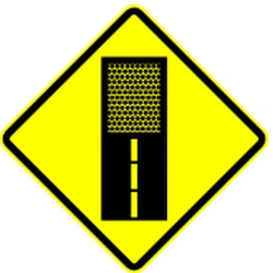 Warning for an unpaved road surface.