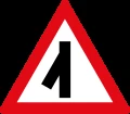 Skewed side road junction ahead to left