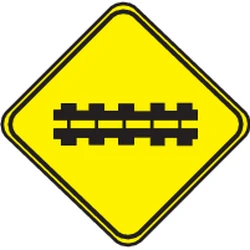 Warning for a railroad crossing with barriers.